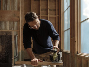 A home improvement specialist operating a cordless saw.