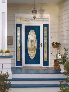 Blue front entry door with oval glass panel and rectangular sidelights. Wrought-iron decoration in panel above transom.